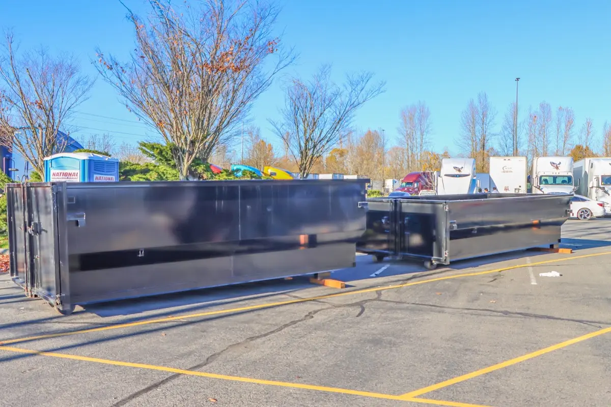 Professional dumpster rental service with roll-off container on residential driveway in McKinleyville